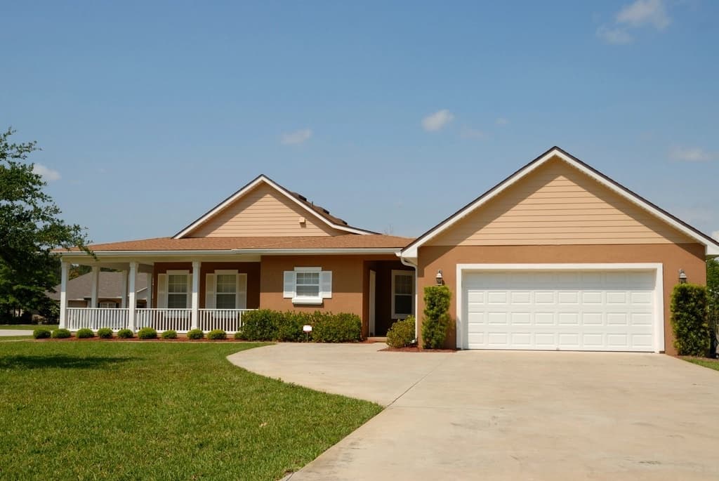 Ranch-style home with a white two-car garage door